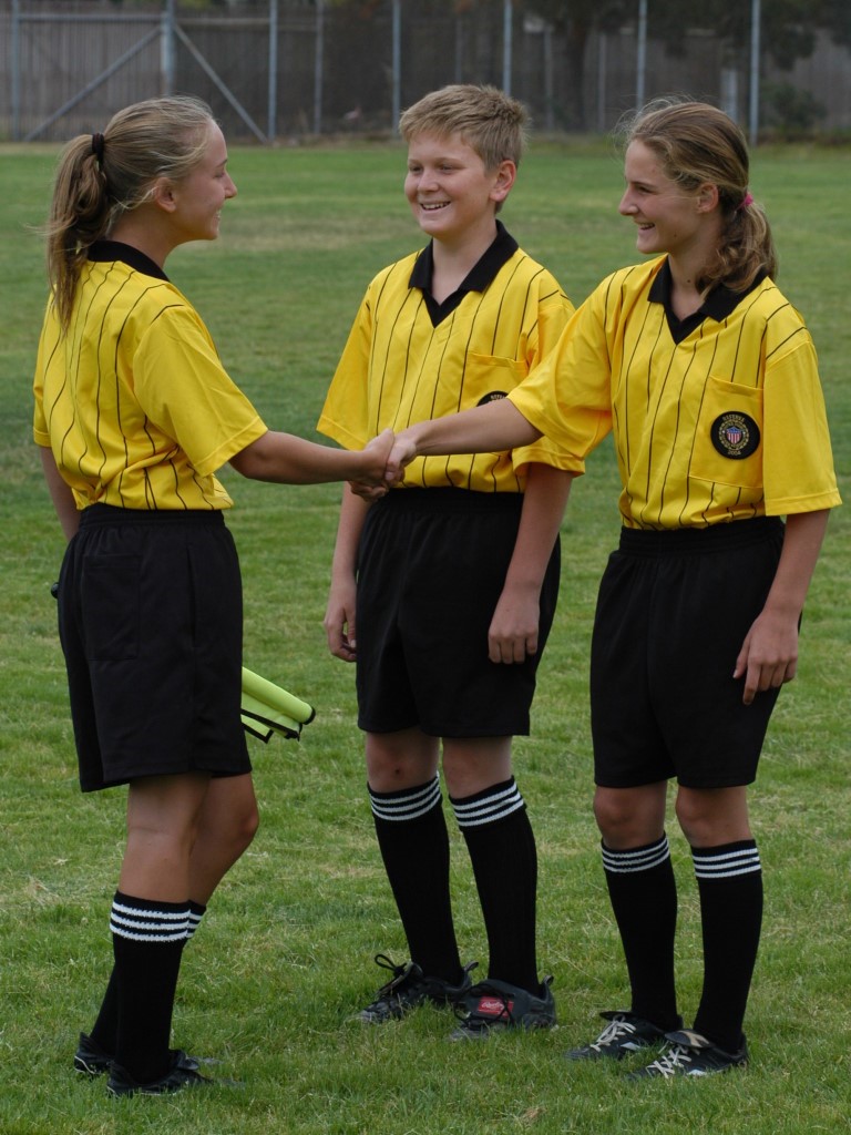 3 youth referees talking