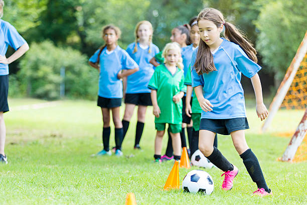 Young girls practicing her soccer skills