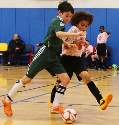 Two kids playing futsal