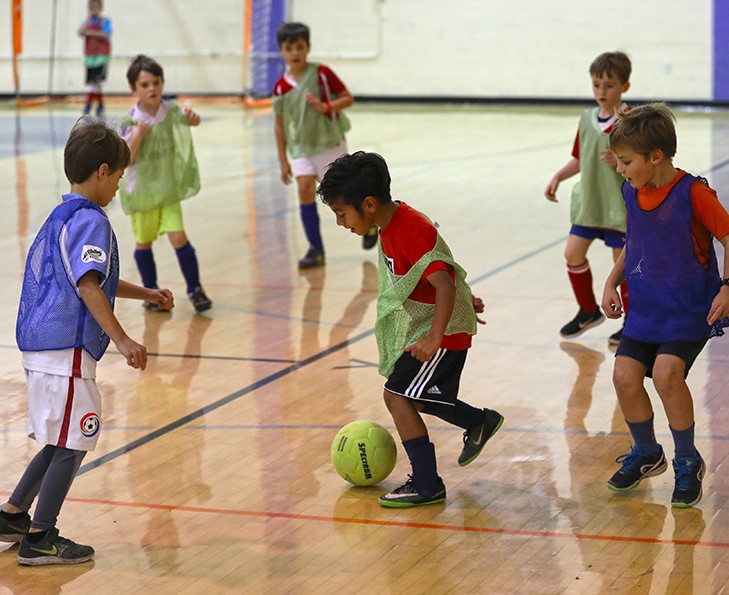 Children playing indoor soccer