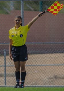 Young referee signaling with a flag